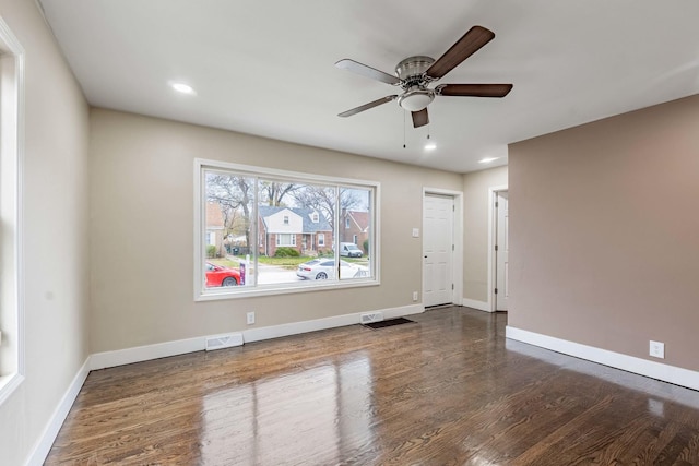 spare room with ceiling fan and dark hardwood / wood-style flooring