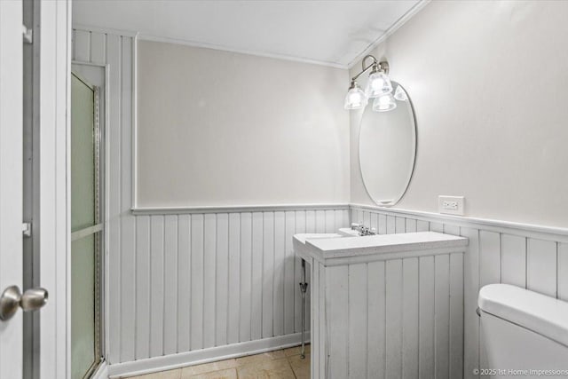 bathroom featuring vanity, toilet, and crown molding