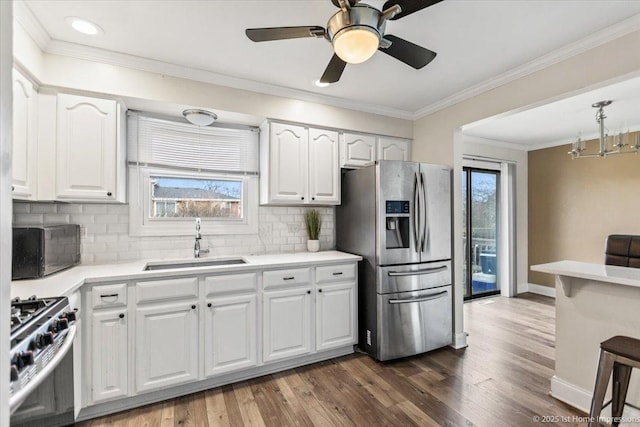 kitchen featuring tasteful backsplash, white cabinetry, sink, and appliances with stainless steel finishes