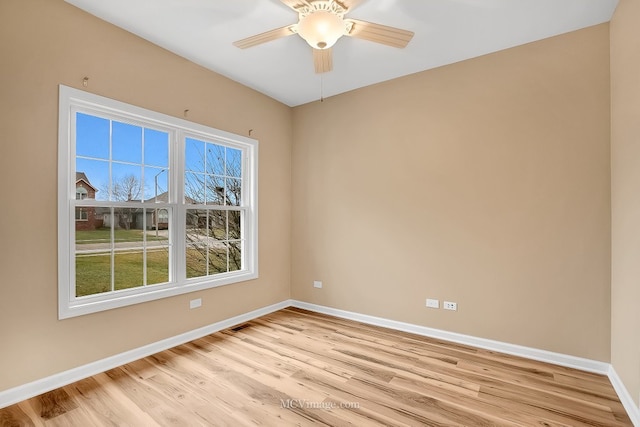 spare room with light hardwood / wood-style flooring and ceiling fan