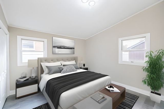 bedroom with hardwood / wood-style flooring, ornamental molding, and a closet