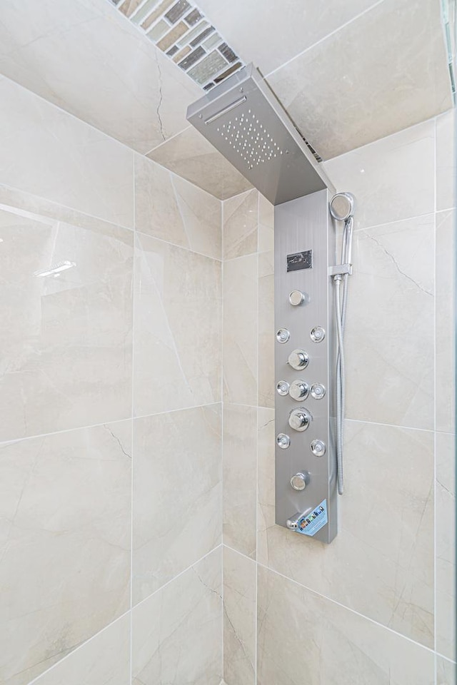 bathroom with tiled shower