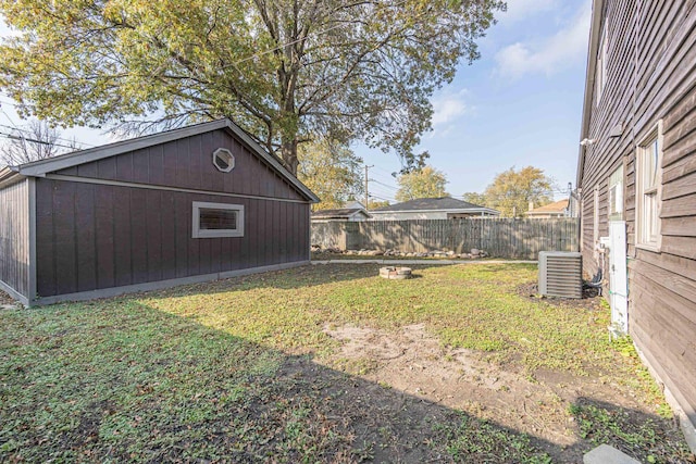 view of yard featuring an outbuilding and central air condition unit