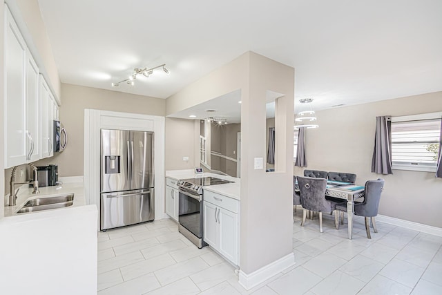 kitchen featuring white cabinets, stainless steel appliances, and sink