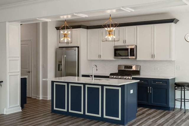 kitchen featuring decorative light fixtures, white cabinetry, and appliances with stainless steel finishes