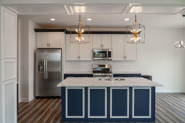 kitchen featuring white cabinets, sink, hanging light fixtures, light stone countertops, and appliances with stainless steel finishes