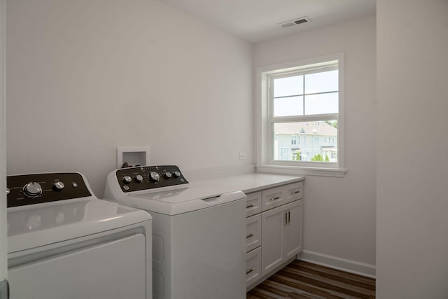 washroom featuring dark wood-type flooring, cabinets, and independent washer and dryer