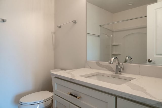 bathroom with vanity, toilet, and walk in shower