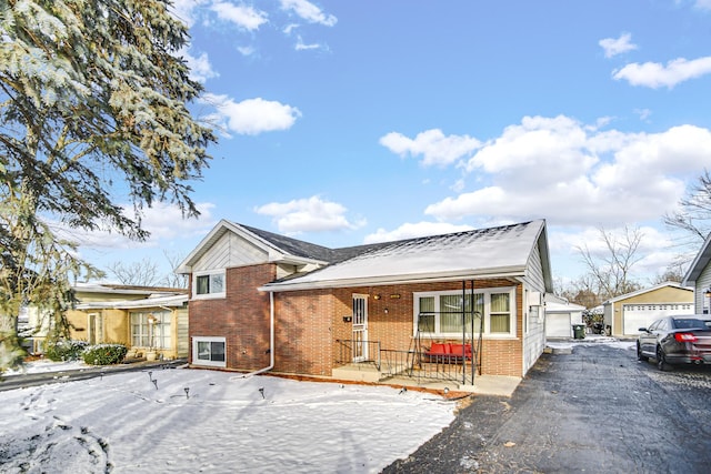 view of front of property with a garage and an outdoor structure