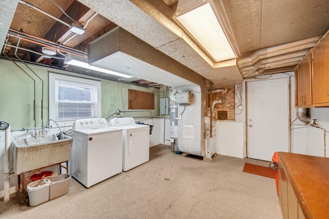 laundry area with washing machine and dryer, heating unit, and sink