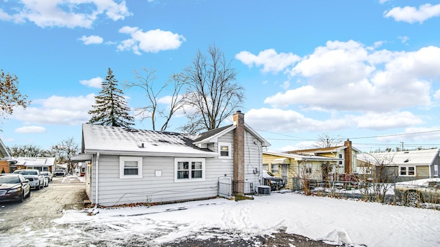 view of snow covered back of property