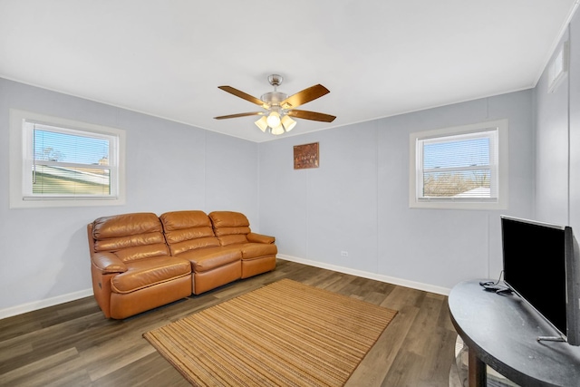 living room with dark hardwood / wood-style flooring and ceiling fan