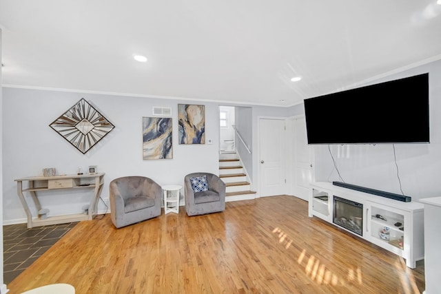 unfurnished room with wood-type flooring and ornamental molding