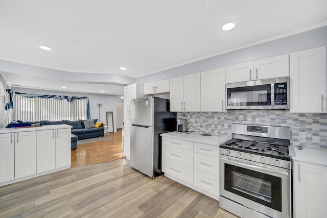 kitchen featuring white cabinetry, light wood-type flooring, and appliances with stainless steel finishes