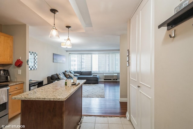 kitchen featuring light stone countertops, light tile patterned flooring, and hanging light fixtures