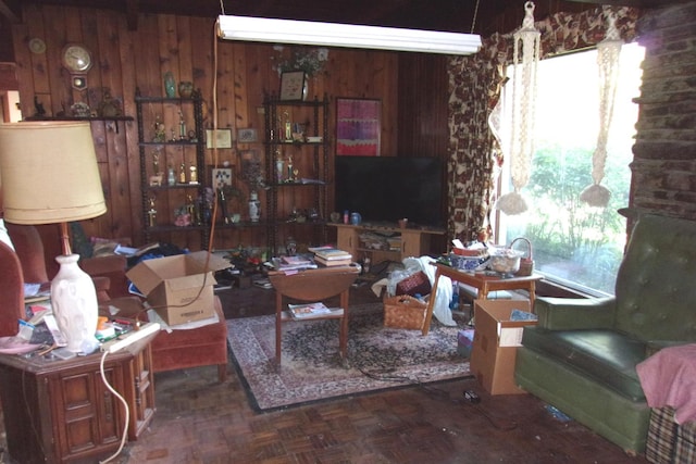 living room featuring wood walls and parquet flooring