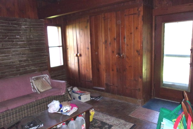 living room with a wealth of natural light and wood walls