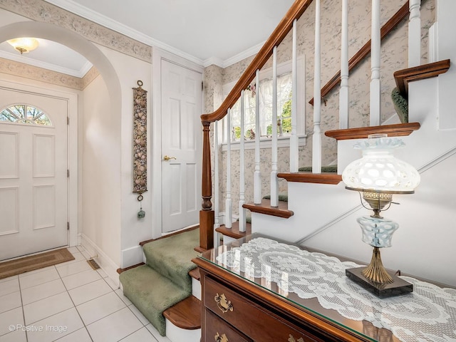 tiled foyer entrance with crown molding