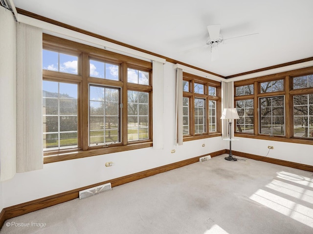 unfurnished sunroom with ceiling fan and a mountain view