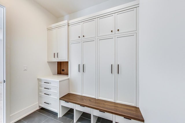 mudroom featuring dark tile patterned flooring