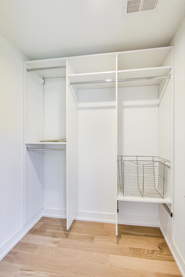 walk in closet featuring hardwood / wood-style flooring