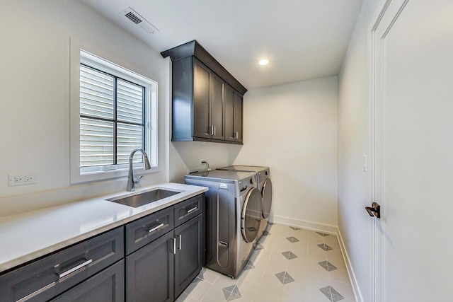 washroom featuring washer and clothes dryer, light tile patterned flooring, cabinets, and sink