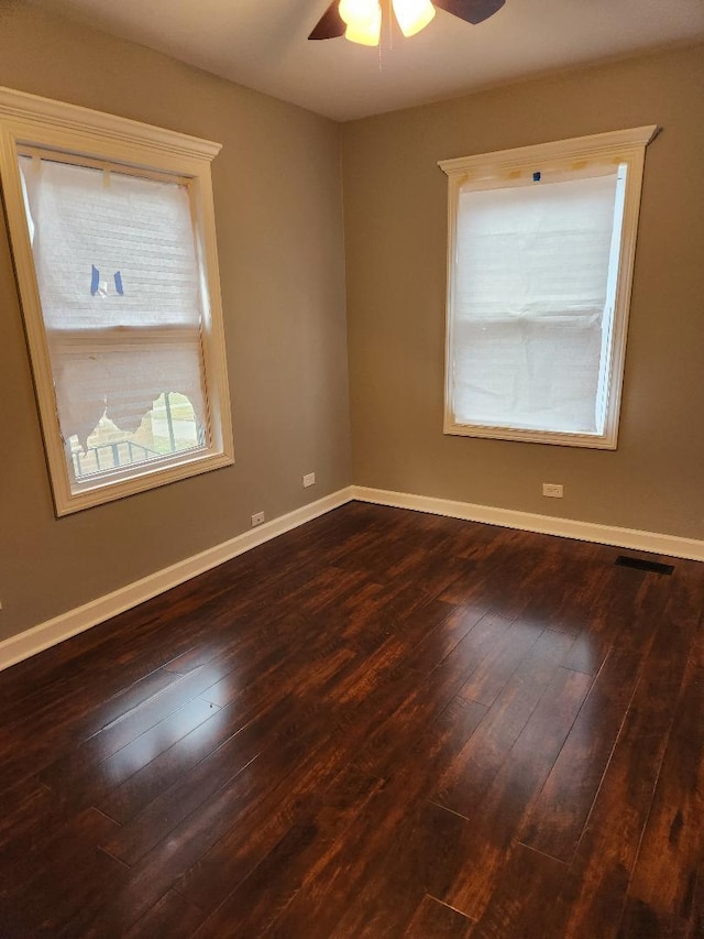 empty room featuring ceiling fan and dark wood-type flooring