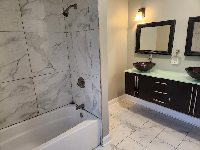 bathroom with tiled shower / bath combo and vanity