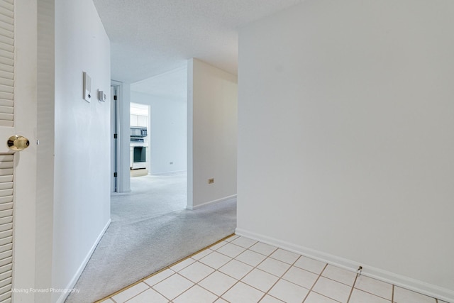 carpeted spare room with a textured ceiling