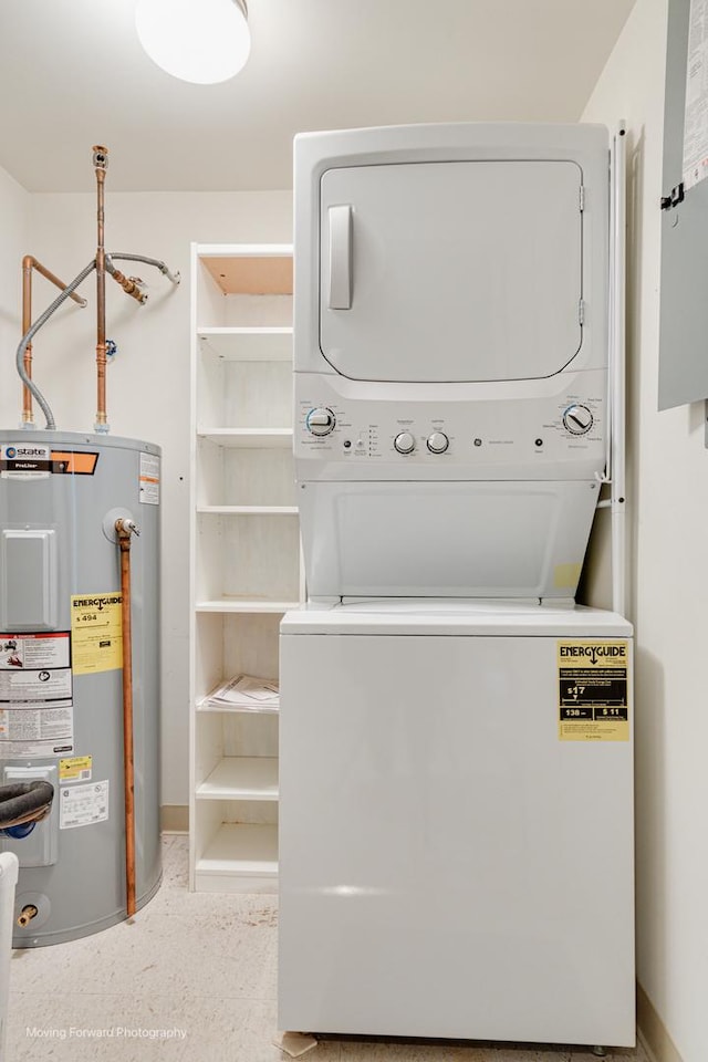 washroom featuring electric water heater and stacked washer / dryer