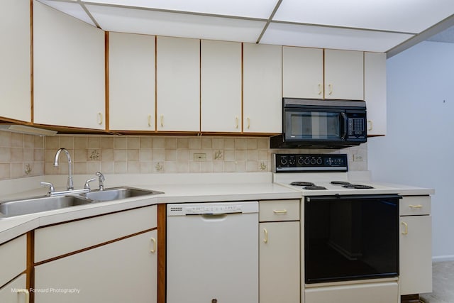 kitchen with white cabinets, white appliances, backsplash, and sink