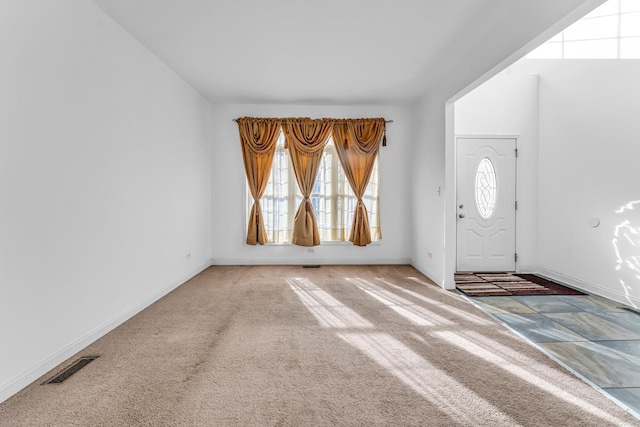 foyer with carpet flooring