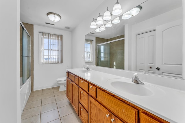 full bathroom with vanity, combined bath / shower with glass door, tile patterned floors, and toilet