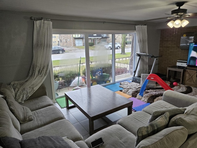 living room featuring ceiling fan and light tile patterned flooring