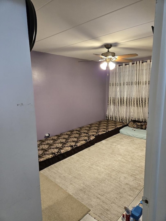 unfurnished bedroom with carpet flooring and ceiling fan