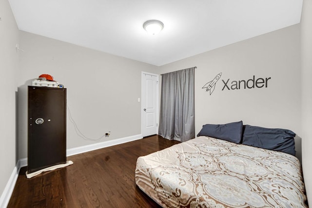 bedroom with dark hardwood / wood-style floors