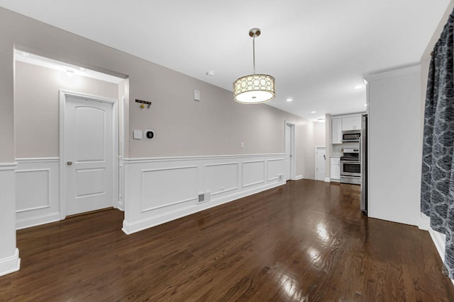 unfurnished dining area with dark hardwood / wood-style flooring