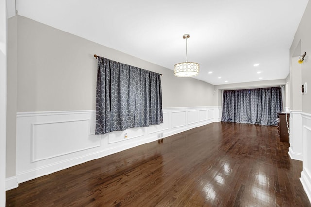 unfurnished dining area featuring dark hardwood / wood-style floors