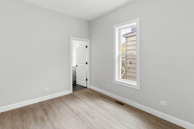 spare room featuring wood-type flooring