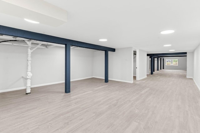 basement with hardwood / wood-style floors