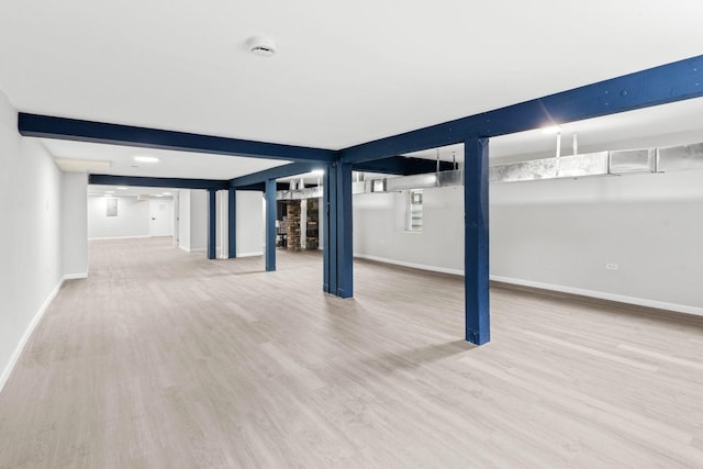 basement with hardwood / wood-style flooring