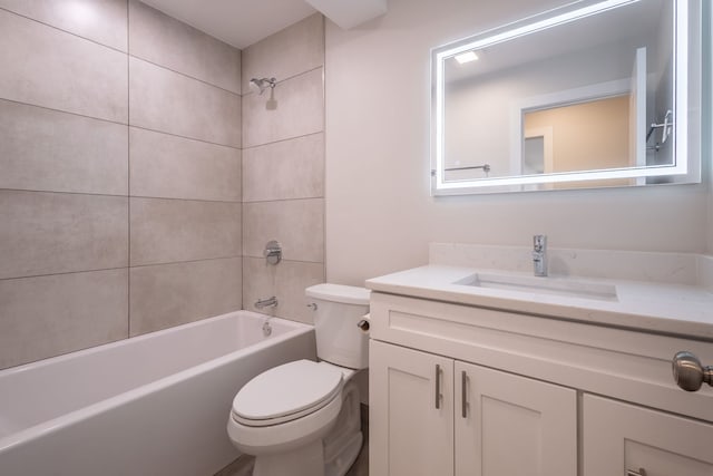 full bathroom with toilet, tiled shower / bath, and vanity