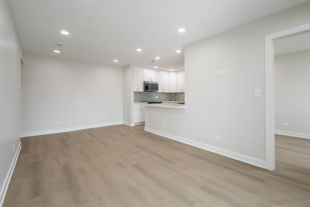 unfurnished living room featuring light hardwood / wood-style flooring