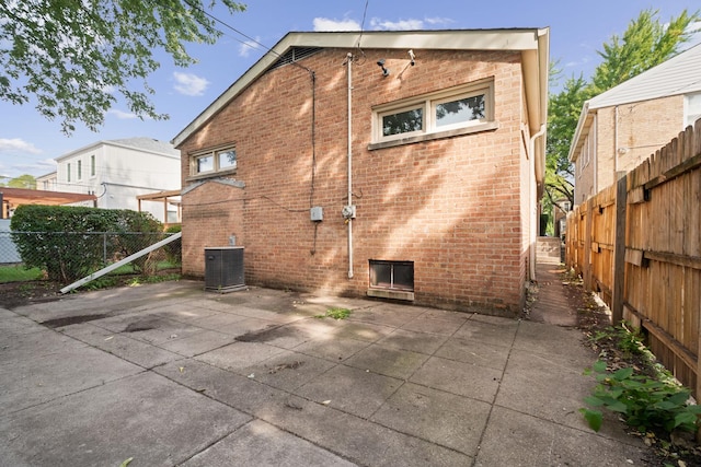 back of house with cooling unit and a patio