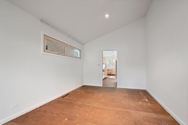 unfurnished room with lofted ceiling