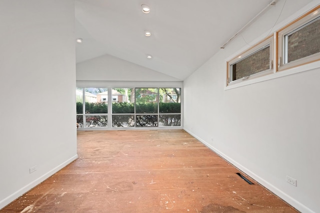 unfurnished living room with vaulted ceiling