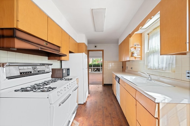 kitchen with white appliances, sink, dark hardwood / wood-style floors, decorative backsplash, and extractor fan