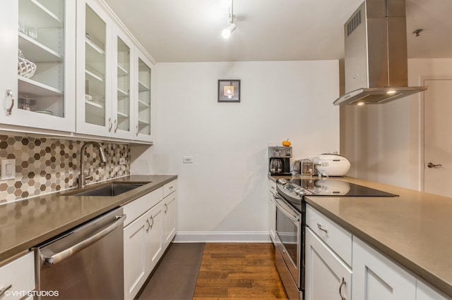 kitchen featuring white cabinetry, sink, stainless steel appliances, dark hardwood / wood-style flooring, and range hood