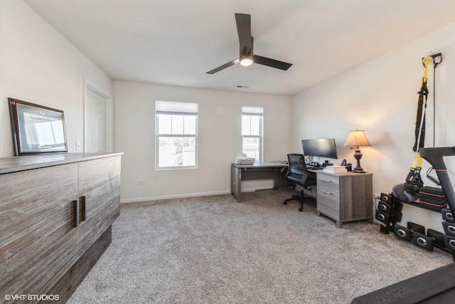 carpeted home office with ceiling fan