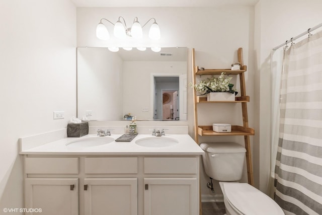 bathroom with a shower with curtain, vanity, and toilet